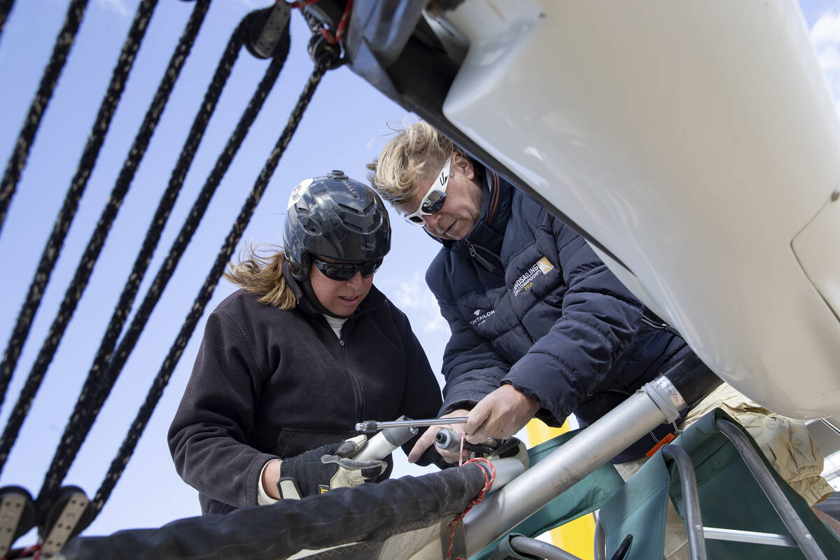 Renee Fields and Nils Meunch, who traveled from Germany for the regatta, work on one of Fields' ...