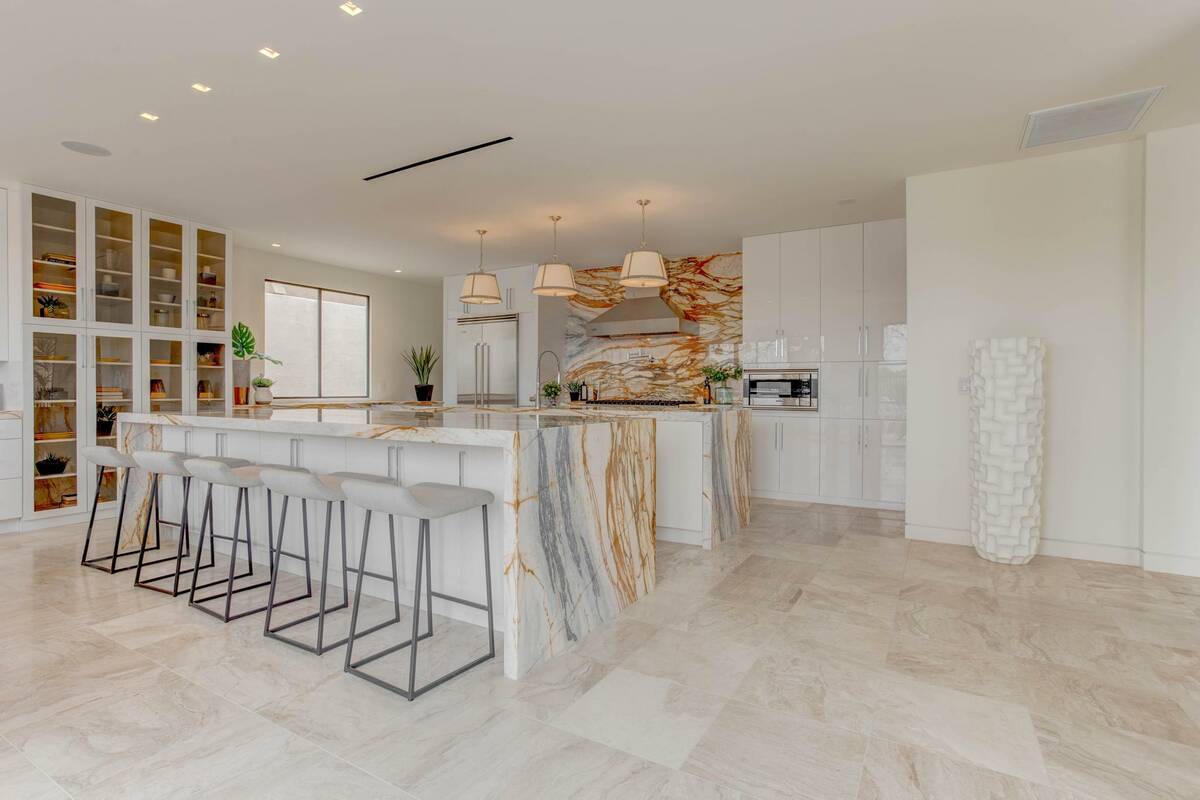 The kitchen has upgraded appliances and marble floors and counters. (Signature Real Estate Group)