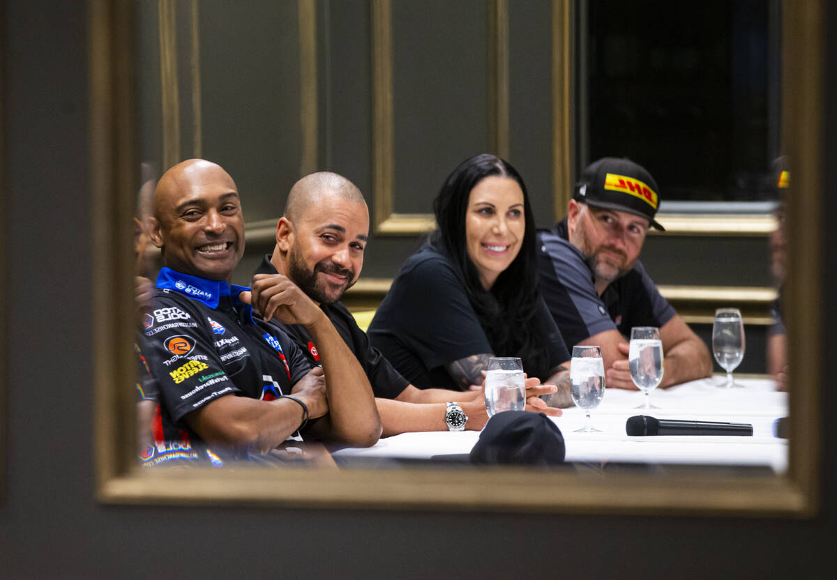 Drivers, from left, Antron Brown, J.R. Todd, Alexis DeJoria, and Shawn Langdon watch a commerci ...