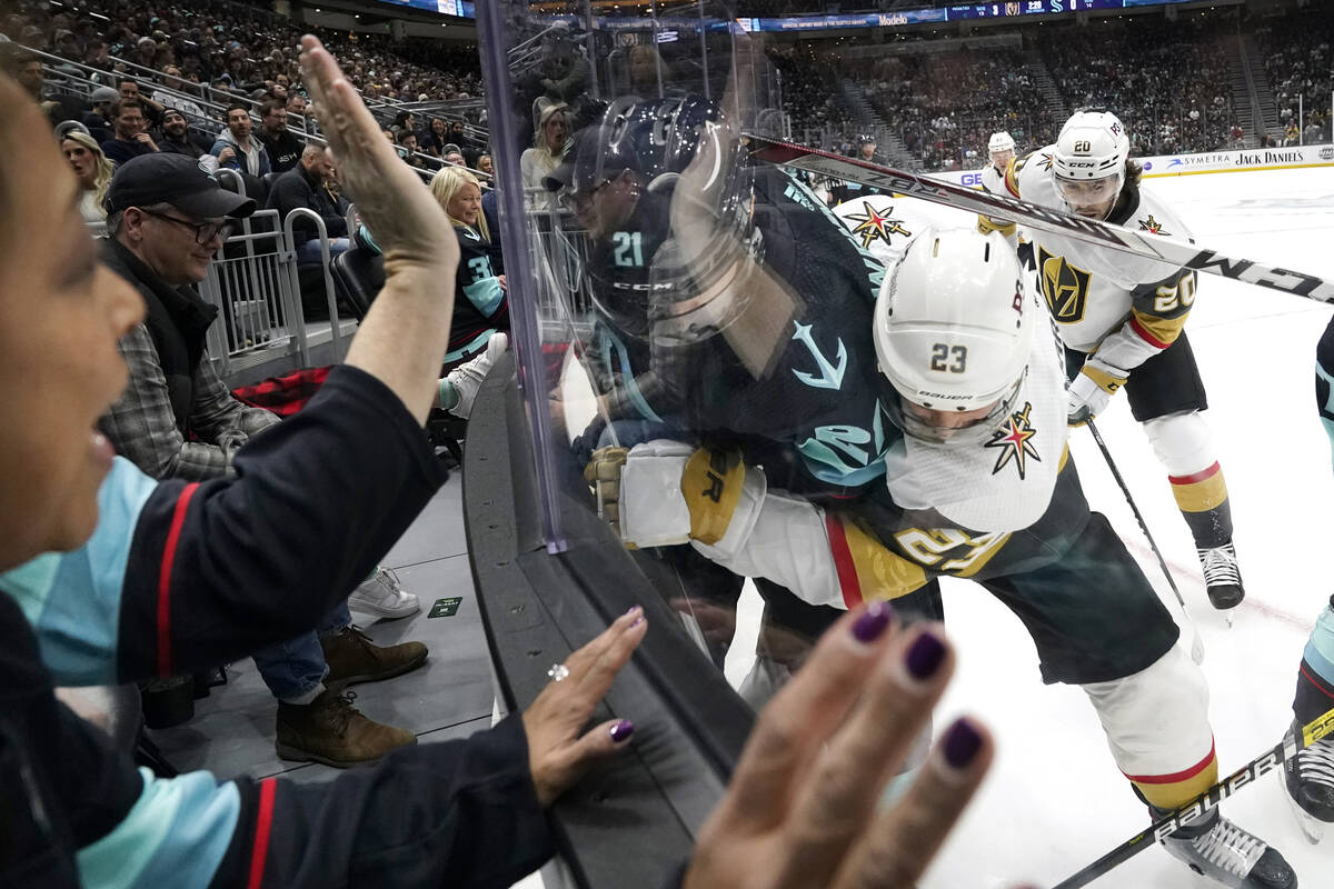 Fans pound on the glass as Seattle Kraken's Alex Wennberg (21) and Vegas Golden Knights' Alec M ...