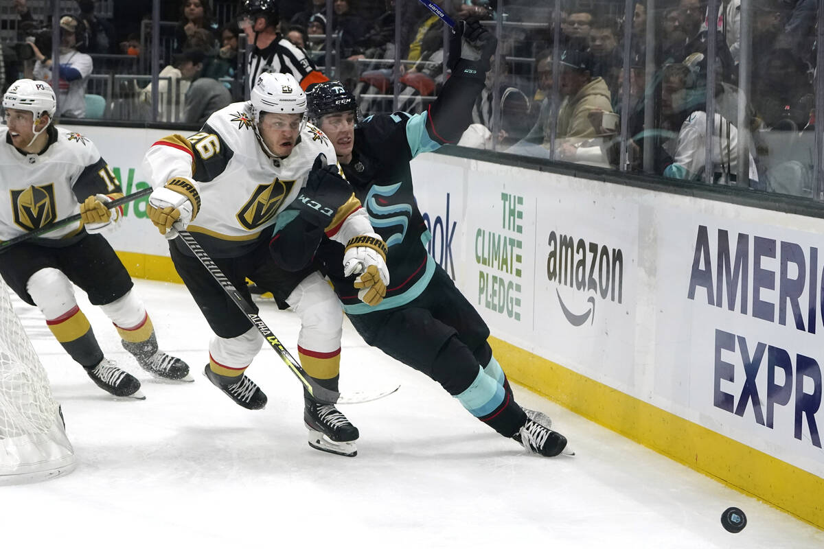 Seattle Kraken's Kole Lind, right, and Vegas Golden Knights' Mattias Janmark chase the puck dur ...