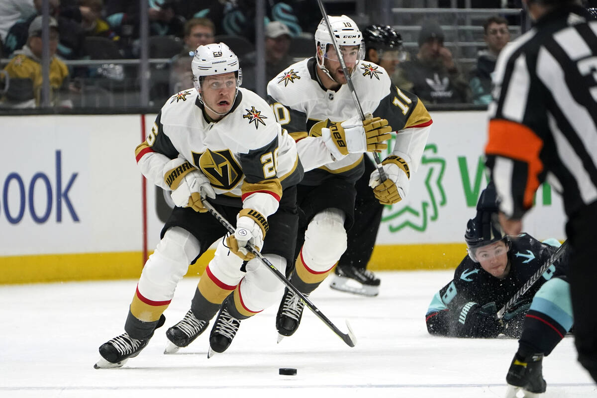 Vegas Golden Knights' Mattias Janmark, left, and Nicolas Roy skate ahead as Seattle Kraken's Ry ...