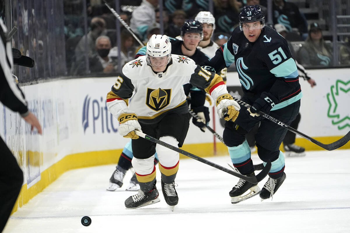 Vegas Golden Knights' Pavel Dorofeyev, left, skates ahead of Seattle Kraken's Derrick Pouliot d ...