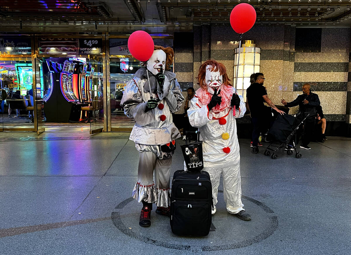A pair of street performers as Pennywise the Dancing Clown work a designated circle at the Frem ...