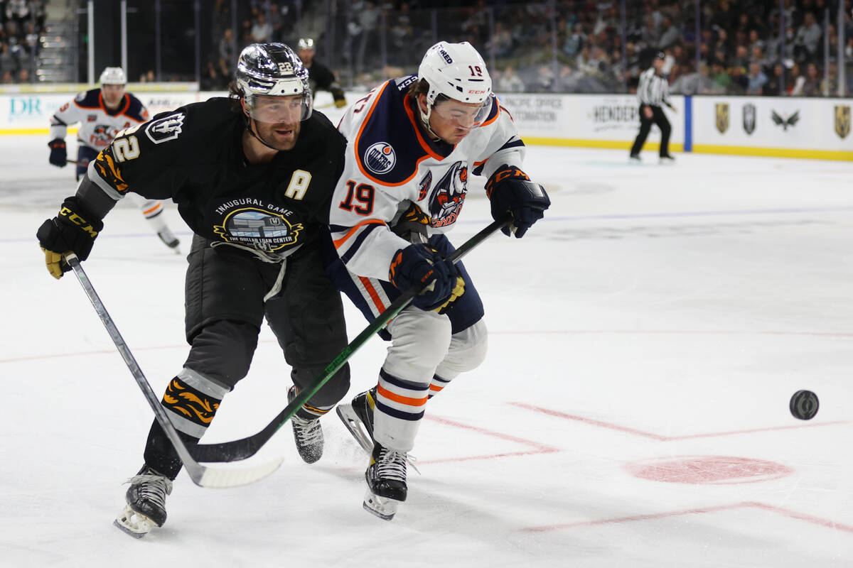 Henderson Silver Knights Ian McCoshenIan (22) and Bakersfield Condors Dino Kambeitz (19) battle ...