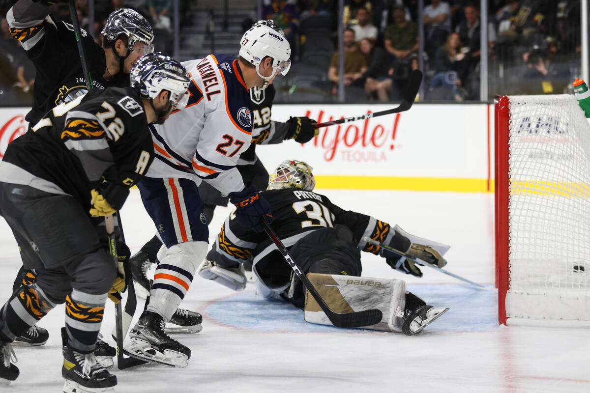 Bakersfield Condors Adam Cracknell (27) shoots for a score against Henderson Silver Knights Jir ...