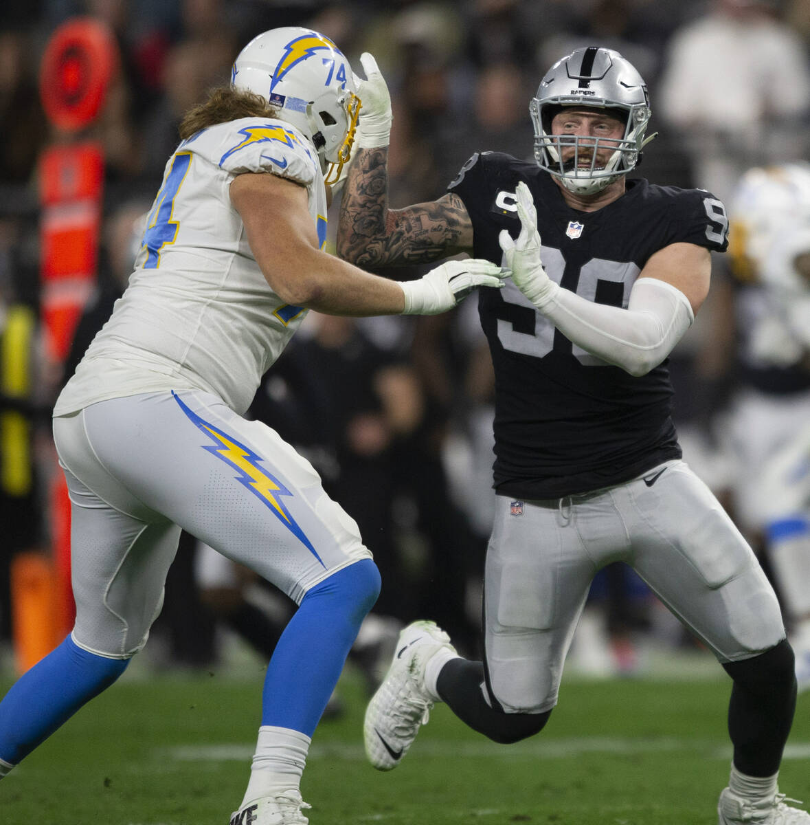 Raiders defensive end Maxx Crosby (98) works to get past Los Angeles Chargers offensive tackle ...