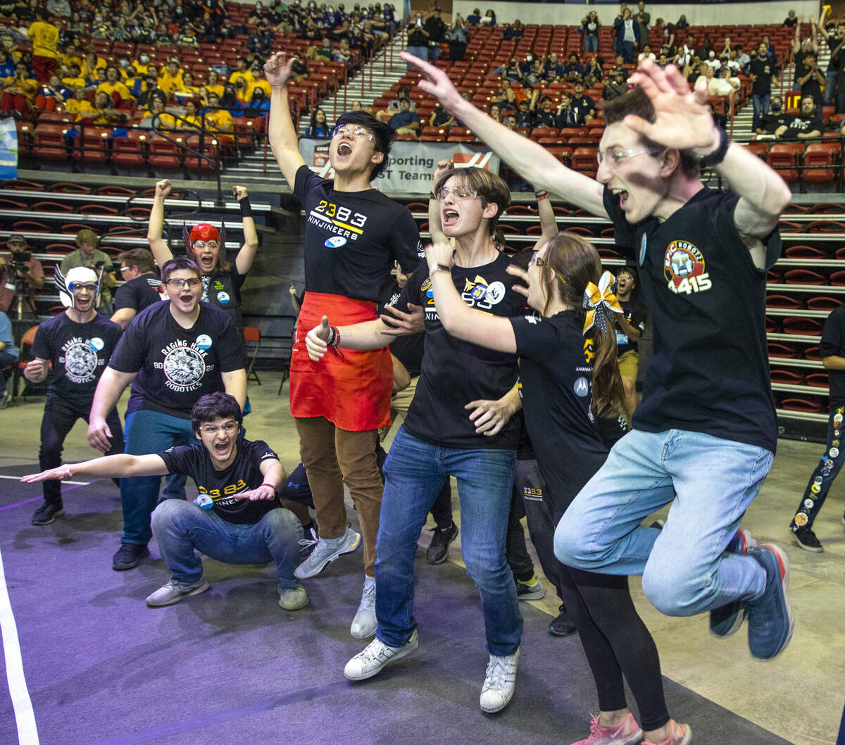 Teammates with the EPIC Robotz of Cerritos, Calif., from right, Ninjineers of Fort Lauderdale, ...