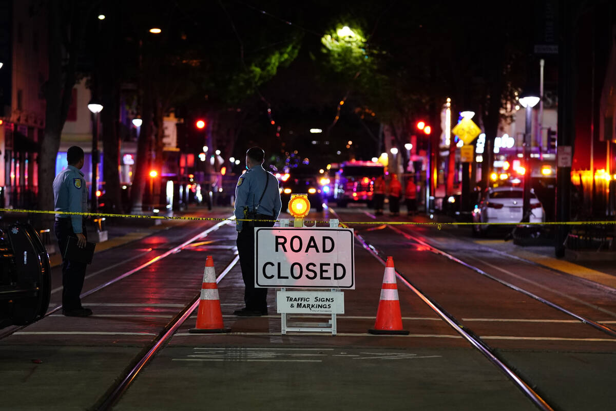A roadblock is set a block away from the scene of an apparent mass shooting in Sacramento, Cali ...