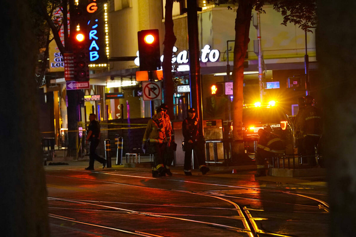Emergency workers walk in downtown Sacramento, Calif., after an apparent mass shooting Sunday, ...