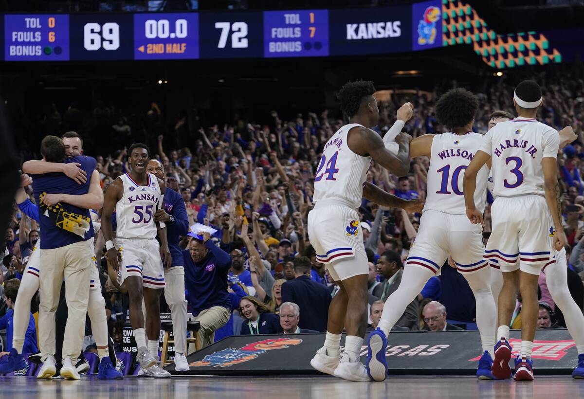 Kansas players celebrate after a college basketball game against North Carolina in the finals o ...