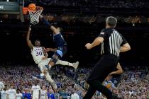 Kansas guard Ochai Agbaji (30) shoots as Villanova forward Eric Dixon defends during the second ...