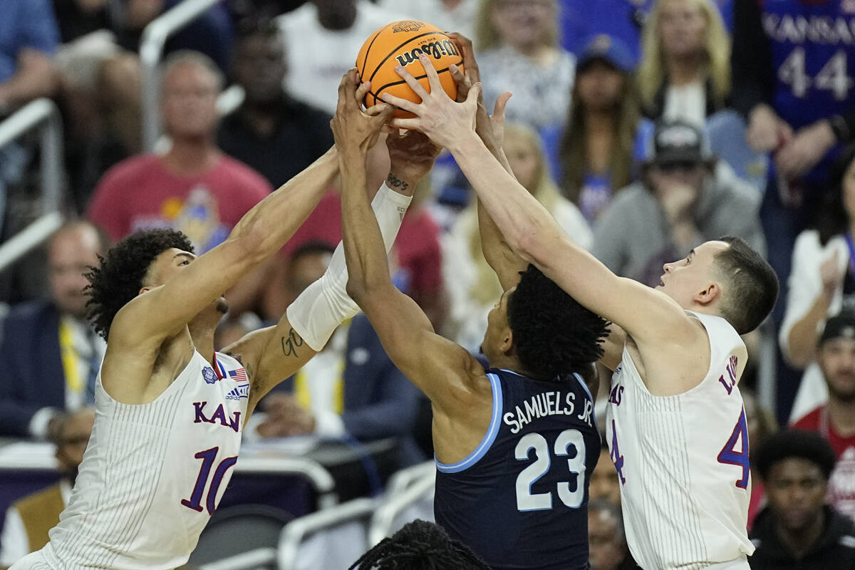 Kansas forward Mitch Lightfoot, left, and Kansas forward Jalen Wilson (10) vie for a rebound ag ...