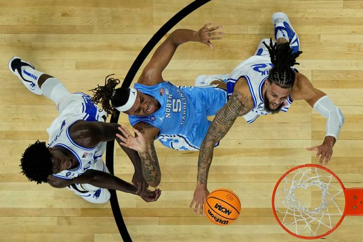 Duke forward Theo John, right, battles North Carolina forward Armando Bacot (5) for the rebound ...