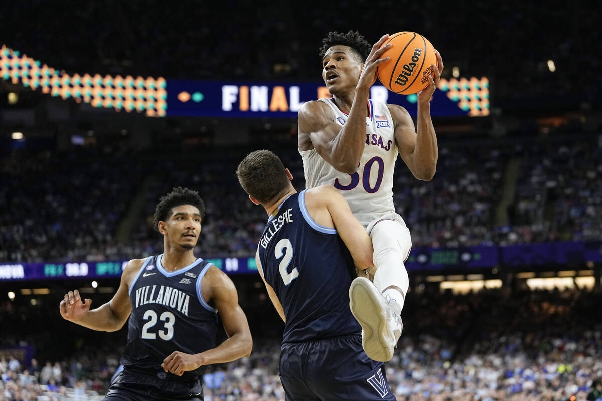 Kansas guard Ochai Agbaji (30) drives against Villanova's Collin Gillespie (2) during the secon ...