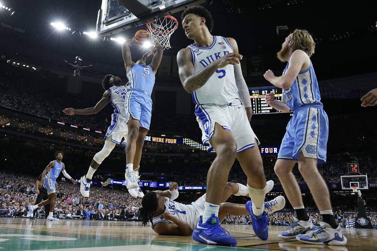 North Carolina forward Armando Bacot (5) shoots past Duke guard Jaylen Blakes during the second ...