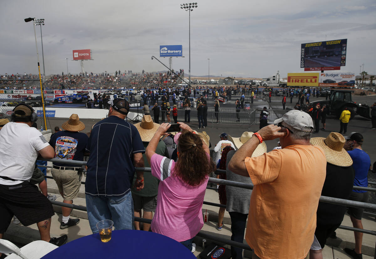 Attendees watch drivers compete at the NHRA Four-Wide Nationals at The Strip at Las Vegas Motor ...