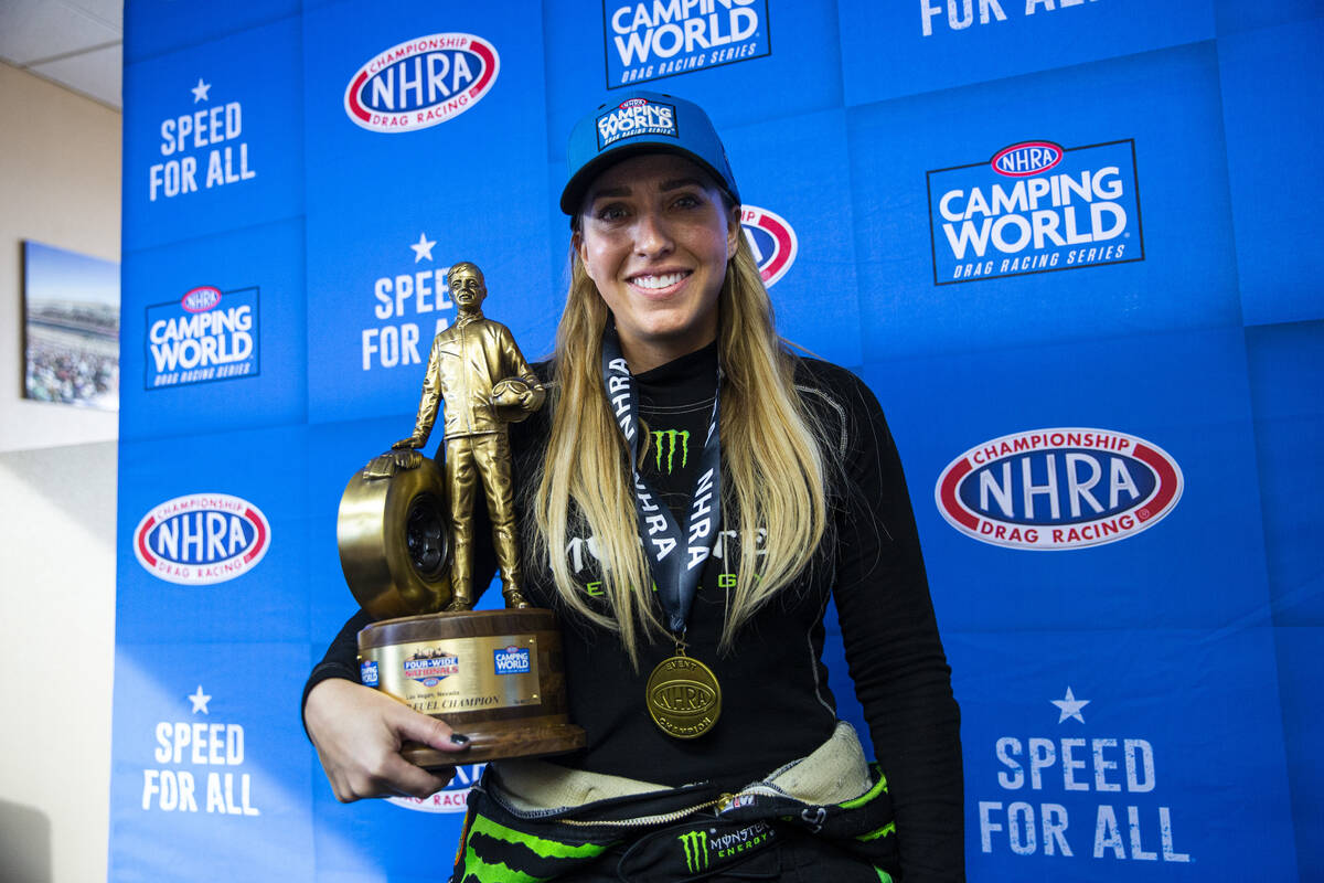Top Fuel driver Brittany Force poses with her trophy after winning in Top Fuel at the NHRA Four ...