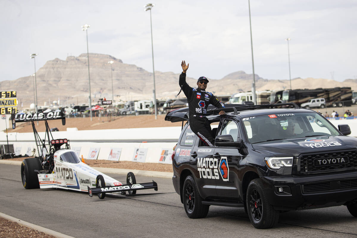 Top Fuel driver Antron Brown acknowledges the crowd after competing in the Top Fuel final at th ...