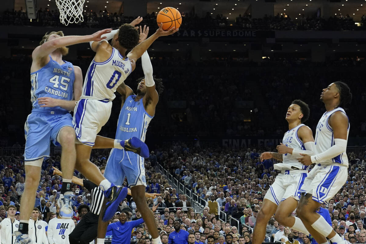 Duke guard Wendell Moore Jr. (0) shoots against North Carolina forward Brady Manek (45) during ...