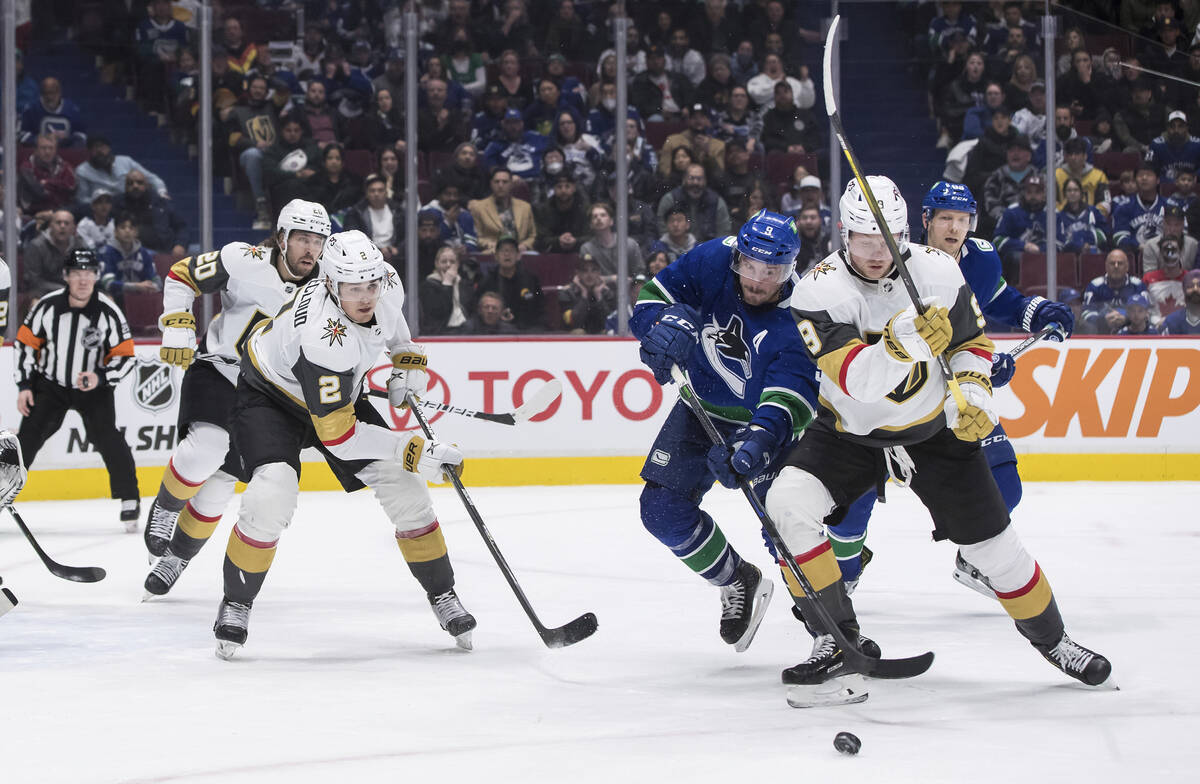 Vancouver Canucks' J.T. Miller, second from right, and Vegas Golden Knights' Jack Eichel, right ...