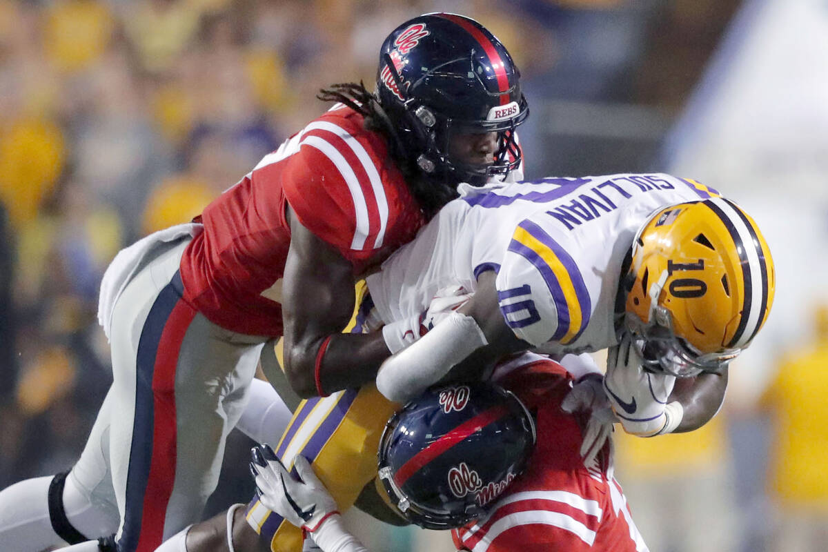 LSU wide receiver Stephen Sullivan (10) is stopped by Mississippi linebacker Kevontae' Ruggs, l ...