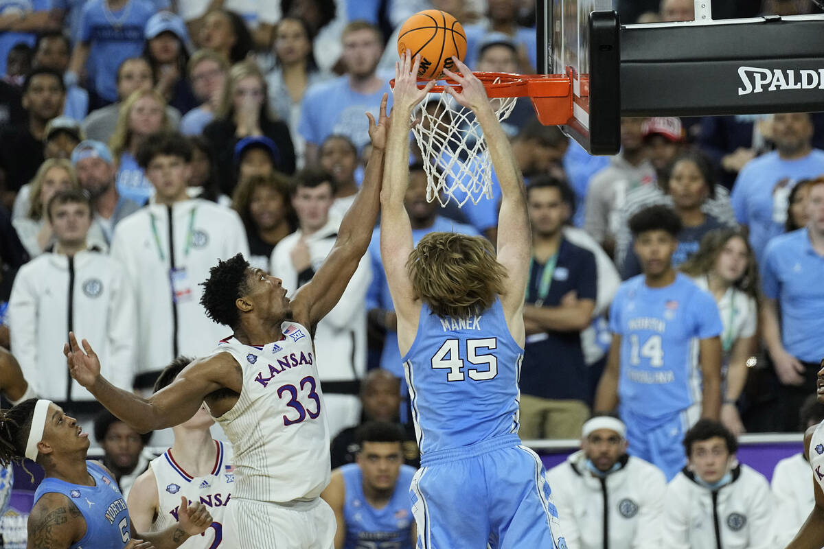 North Carolina forward Brady Manek (45) tips the ball in against Kansas forward David McCormack ...