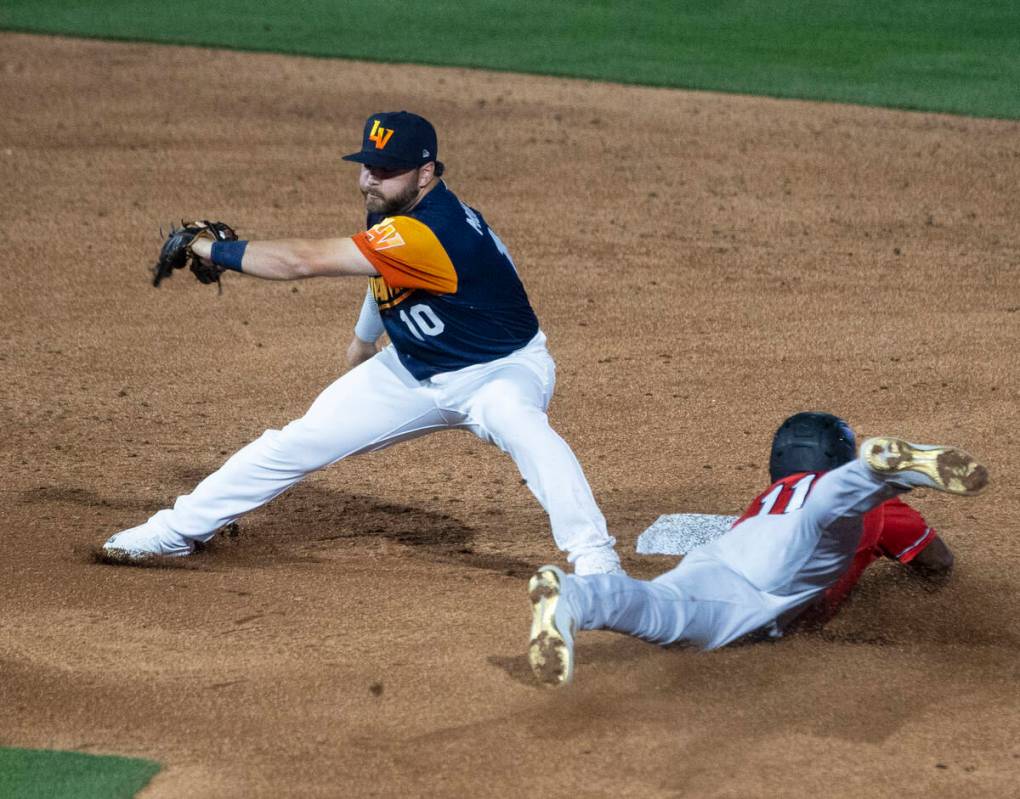 Reno Aces outfielder Stone Garrett (11) dives safe at second as Las Vegas Aviators infielder Na ...