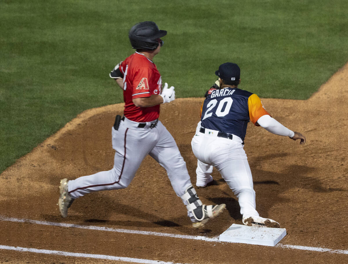 Reno Aces outfielder Buddy Kennedy (16) stretches but unable to stay safe at first as Las Vegas ...