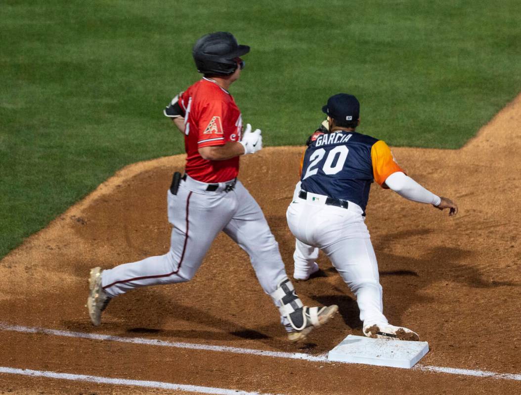 Reno Aces outfielder Buddy Kennedy (16) stretches but unable to stay safe at first as Las Vegas ...