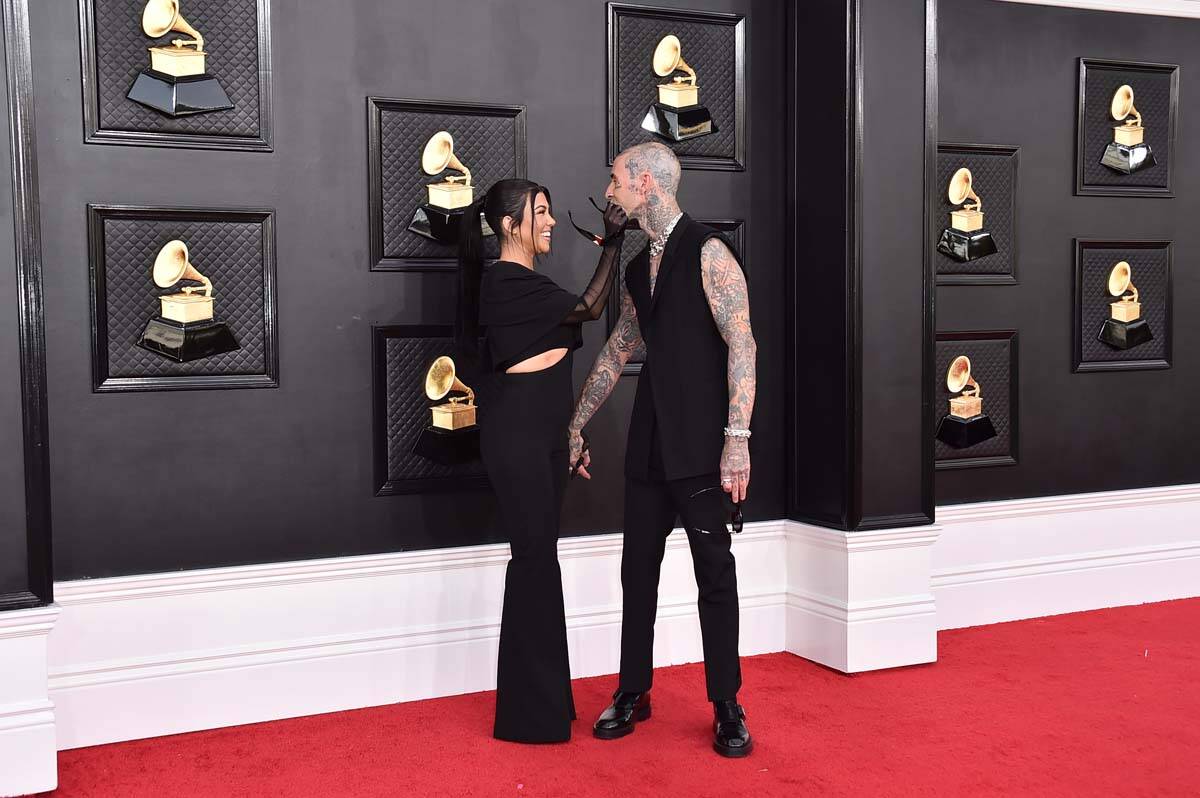 Kourtney Kardashian, left, and Travis Barker arrive at the 64th Annual Grammy Awards at the MGM ...