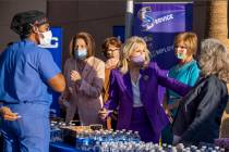 First Lady Jill Biden, center, jokes with Rep. Dina Titus, right, while greeting staff members ...