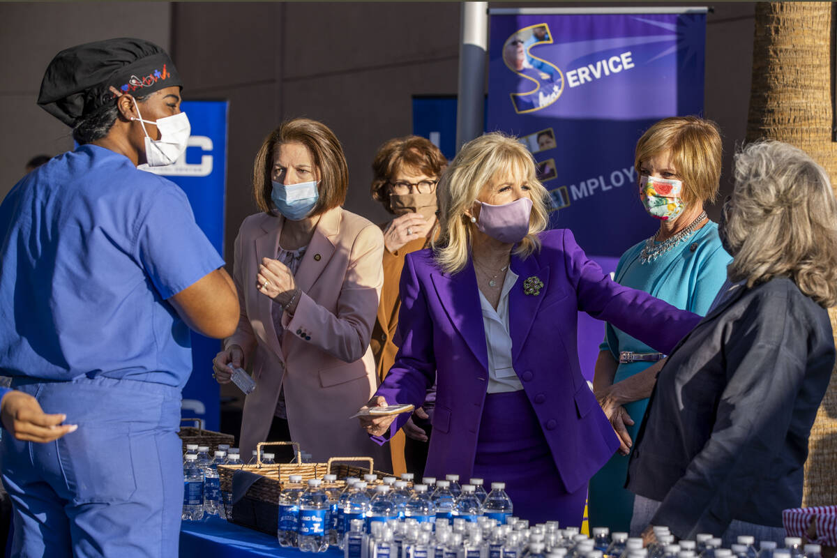 First Lady Jill Biden, center, jokes with Rep. Dina Titus, right, while greeting staff members ...