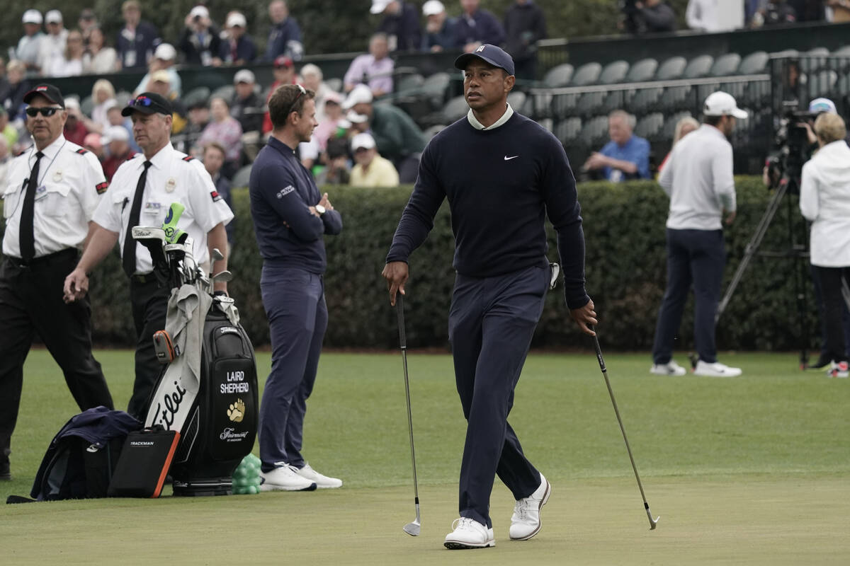 Tiger Woods arrives on the driving range during a practice round for the Masters golf tournamen ...