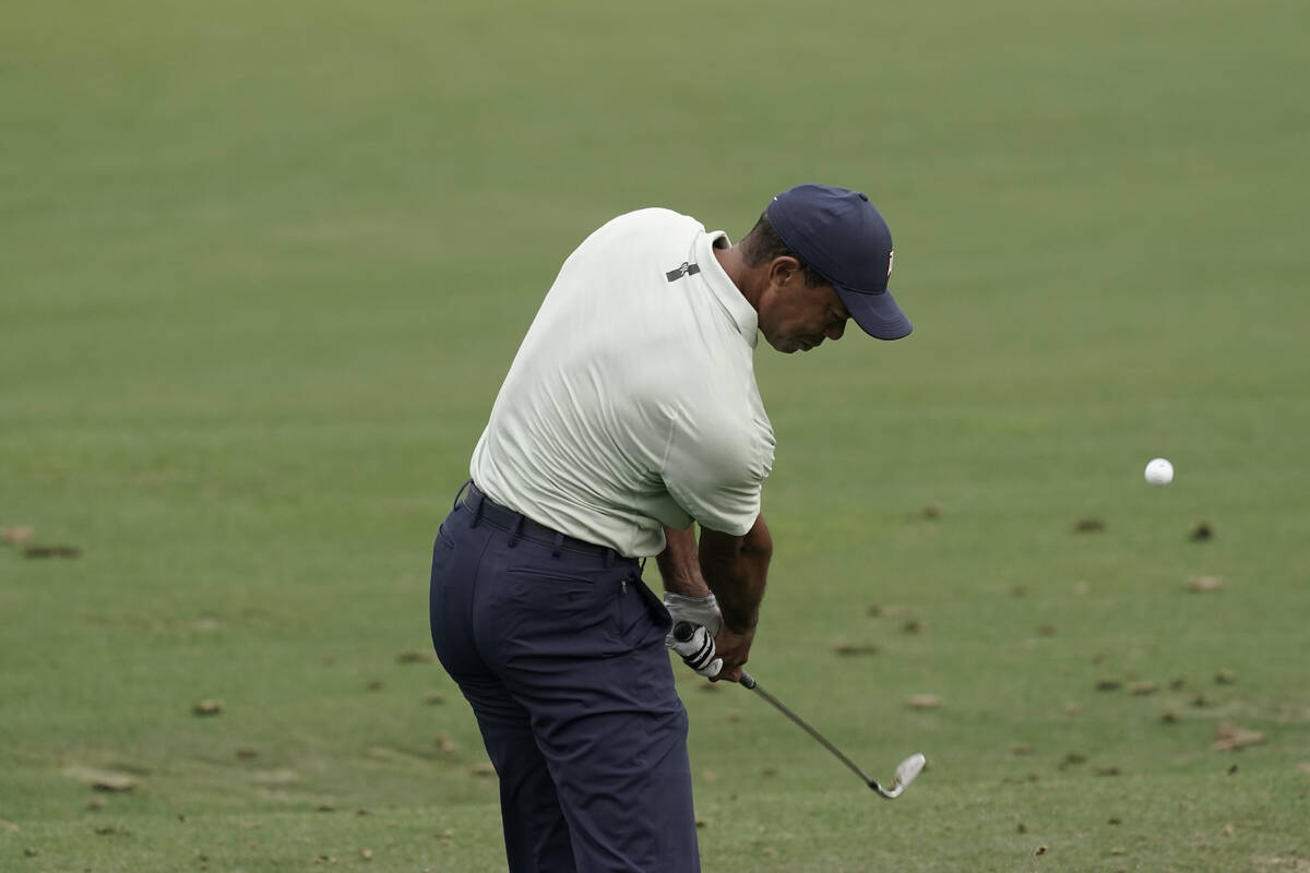 Tiger Woods hits on the driving range during a practice round for the Masters golf tournament o ...