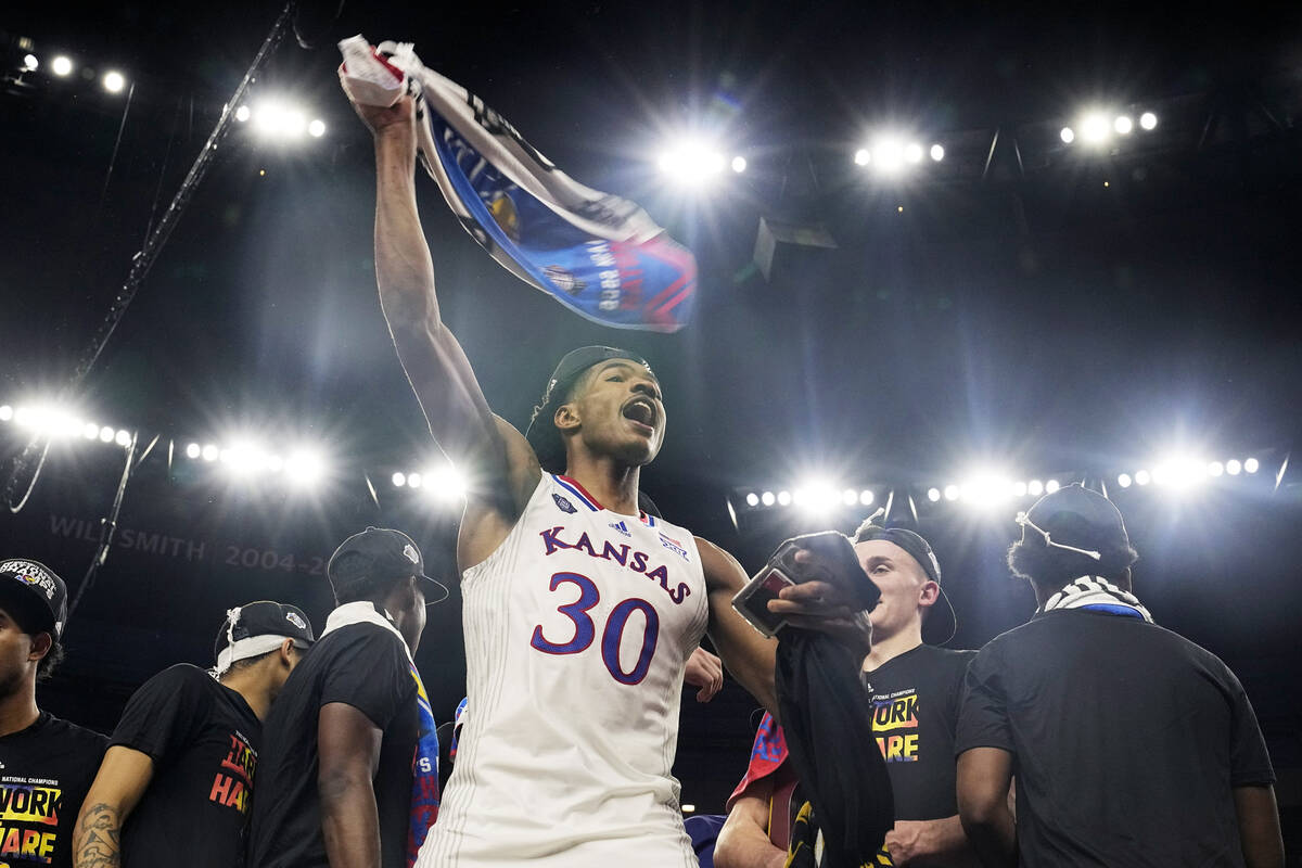 Kansas guard Ochai Agbaji celebrates after their win against North Carolina in a college basket ...