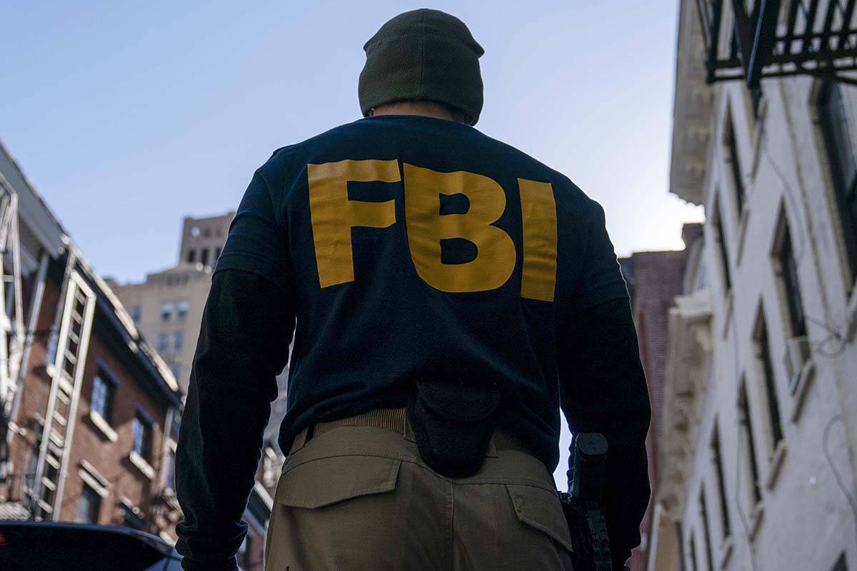 A federal agent stands in New York. (AP Photo/John Minchillo)