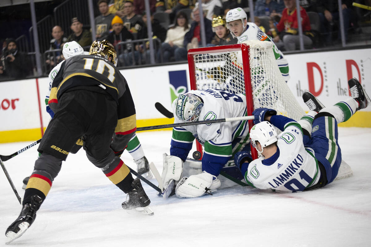 Golden Knights center Nicolas Roy (10) shoots while Canucks goaltender Thatcher Demko (35) save ...