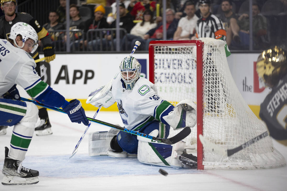 Canucks goaltender Thatcher Demko (35) prepares to save a shot by Golden Knights center Chandle ...
