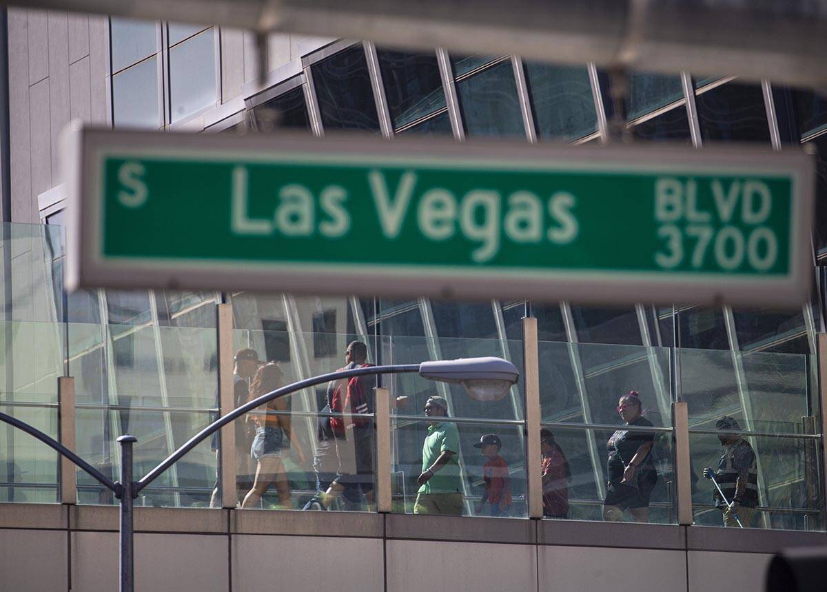 Pedestrians cross a bridge along the Las Vegas Strip on Wednesday, April 6, 2022, in Las Vegas. ...
