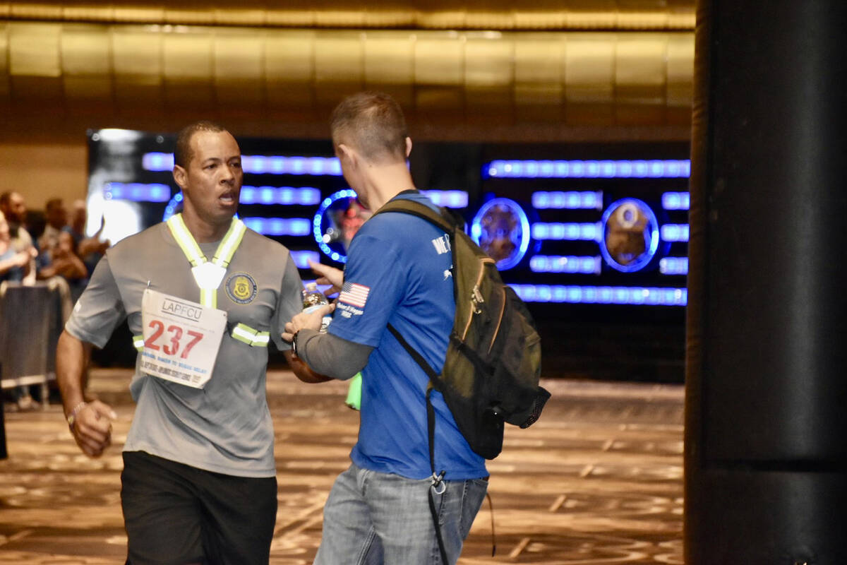 Lawrence Casselle crosses the finish line of the 2022 Challenge Cup/Baker to Vegas Relay at 5:2 ...