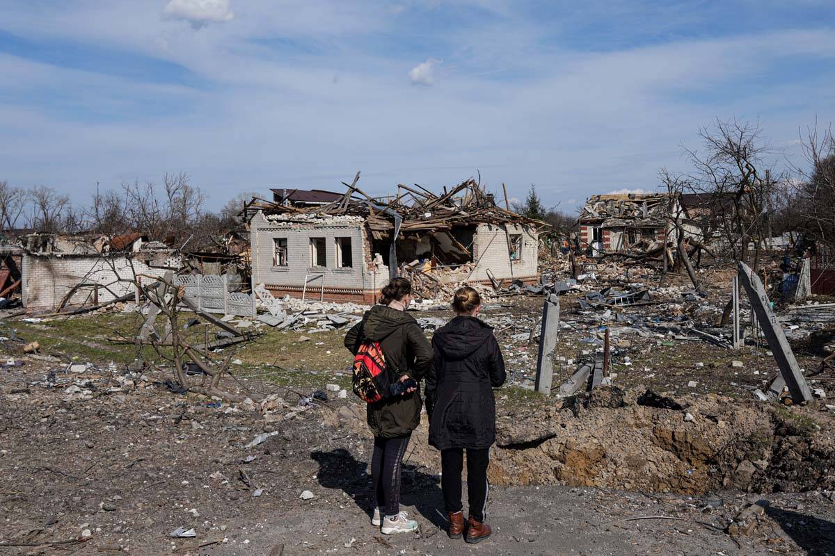 Women look at houses damaged by shelling in Chernihiv, Ukraine, Thursday, April 7, 2022. Ukrain ...