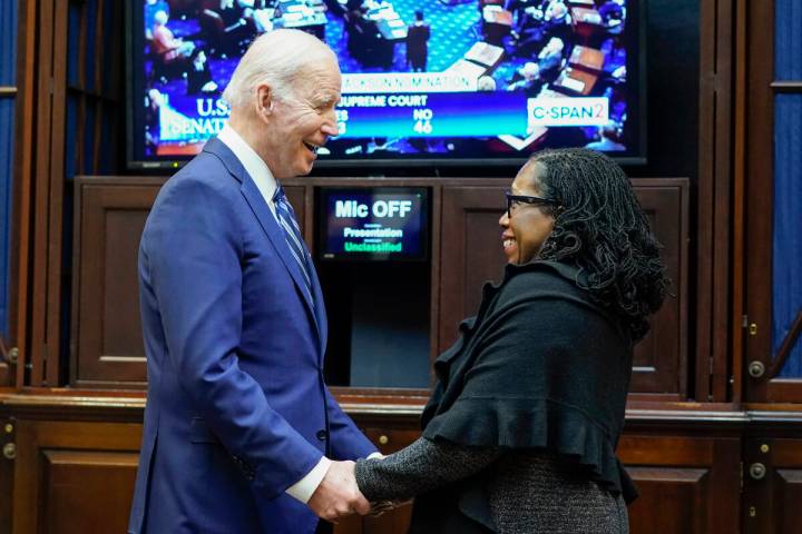 President Joe Biden holds hands with Supreme Court nominee Judge Ketanji Brown Jackson as they ...