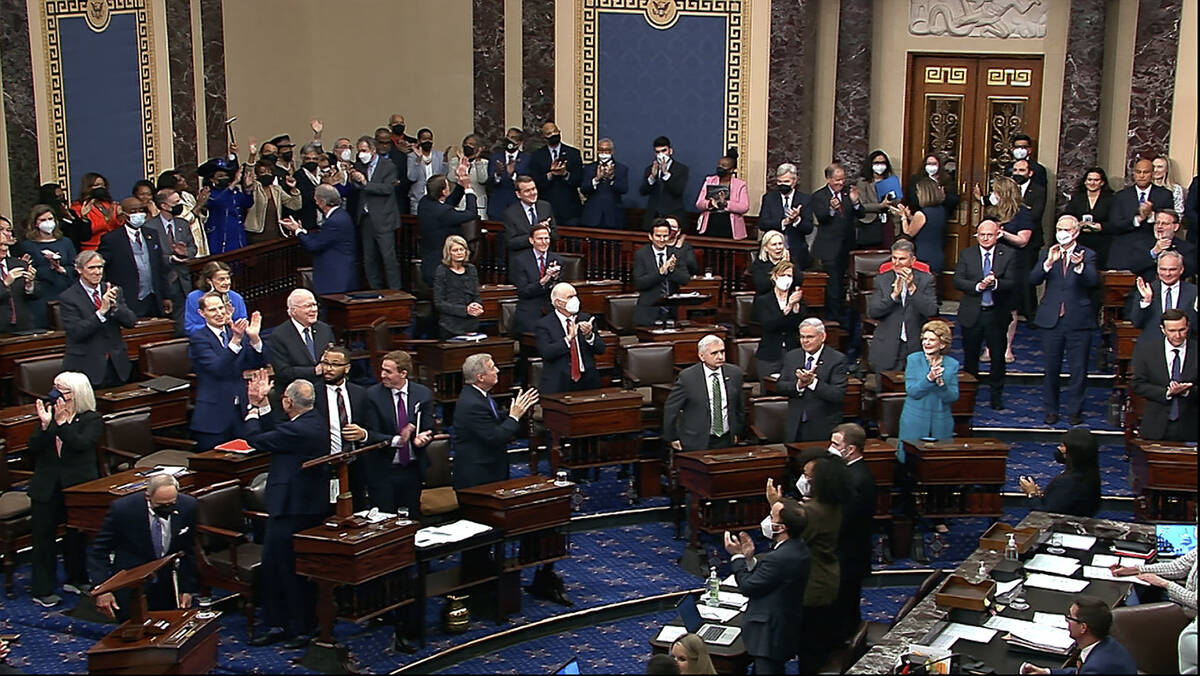 In this image from video from Senate Television, Democrats stand and applaud after the Senate c ...