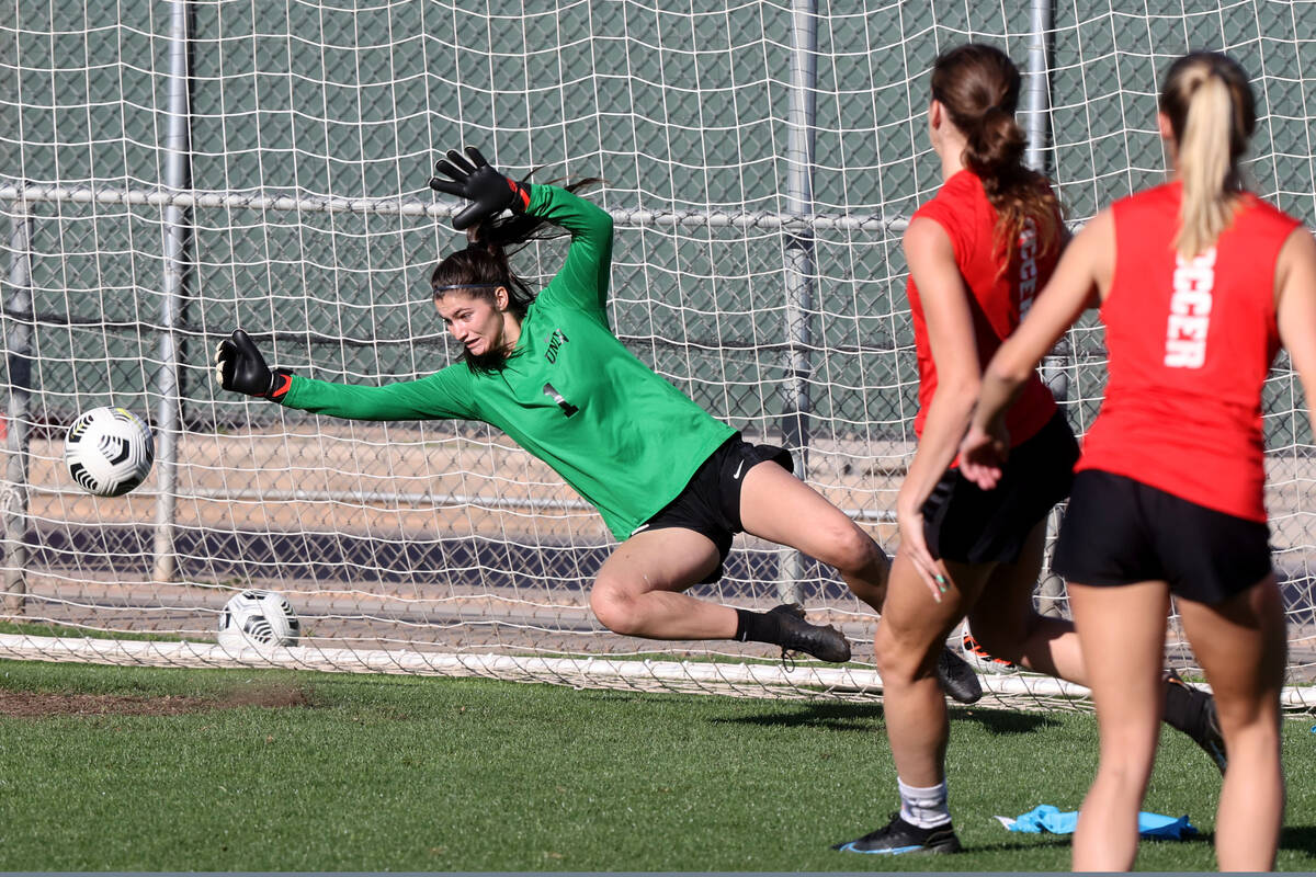 Goalkeeper Charlotte Brisley looks to block a shot during UNLV women’s soccer team pract ...
