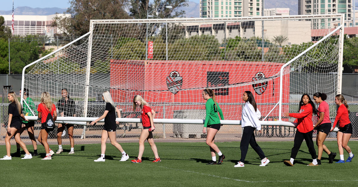 Members of the UNLV women’s soccer team move the goal after practice at Peter Johann Fie ...
