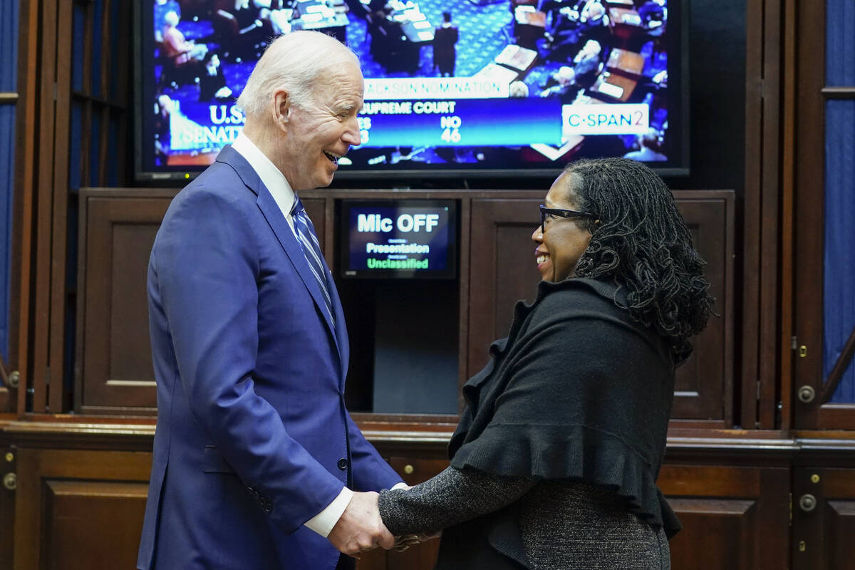 President Joe Biden holds hands with Supreme Court nominee Judge Ketanji Brown Jackson as they ...