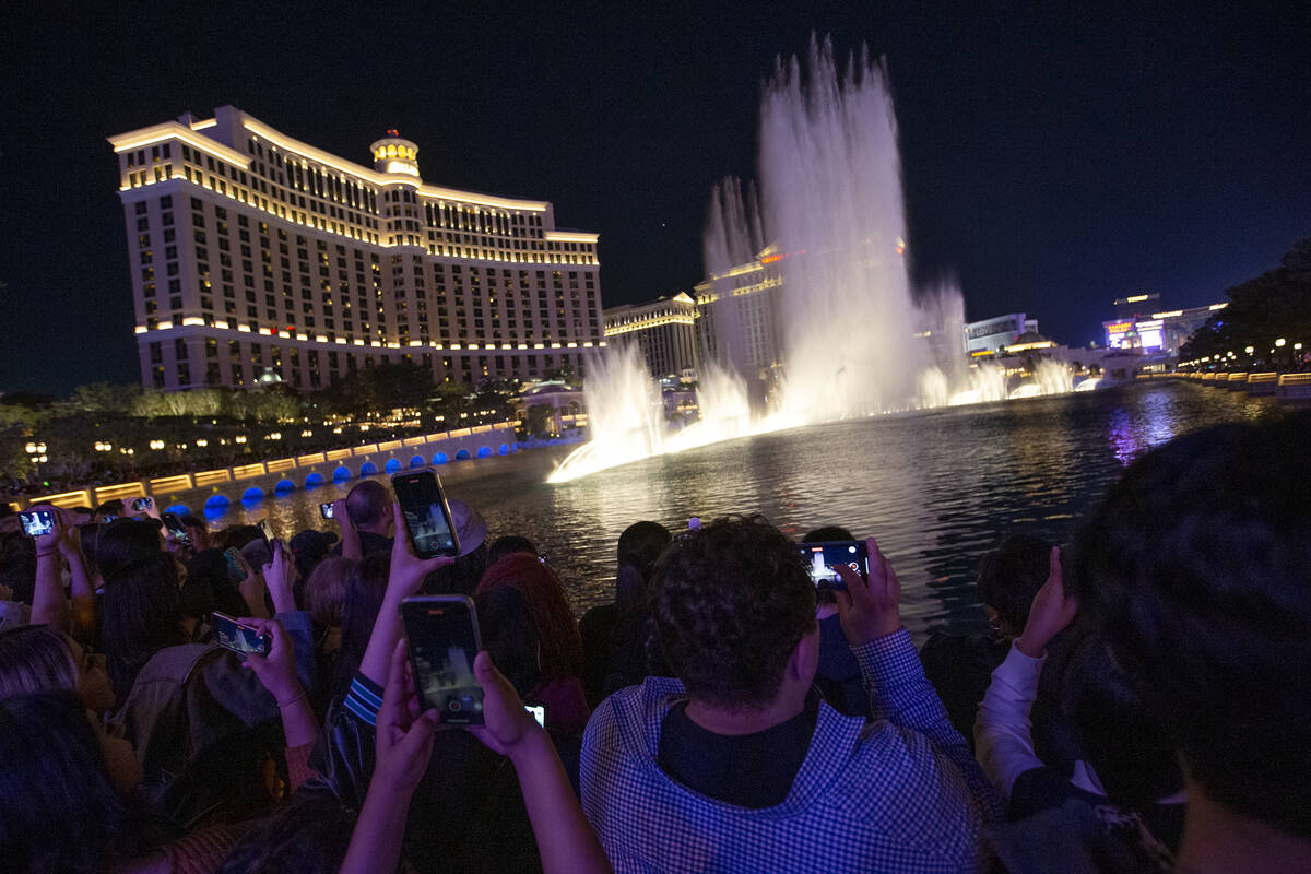 BTS fans line up as the Bellagio Fountain plays a show to songs “Butter” and  ...