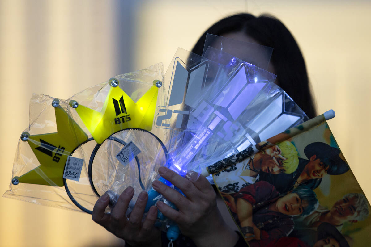 BTS headbands and merchandise is sold to fans before the Korean boy band’s opening show ...