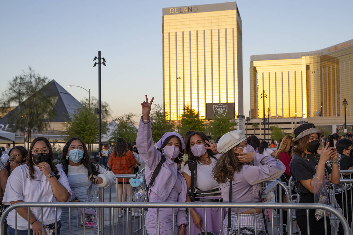 BTS fans, known as the “BTS Army” online, wait in line to enter Allegiant Stadium ...